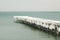 Frozen fishing pier with hanging icicles