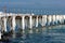 Frozen fishing pier with hanging icicles in a sunny winter day