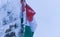 Frozen flag of Hungary in winter landscape on Madaras Harghita mountain