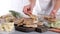 Frozen food. A woman lays out a frozen chop on a board. Frozen ready meals