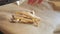 Frozen french fries are laid out by hand on a kitchen baking sheet for cooking in the oven. Slow motion close up view