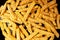 Frozen fries with spices close-up sliced wavy