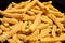 Frozen fries with spices close-up sliced wavy