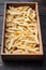 Frozen fries, in wooden box, on old dark  wooden table background