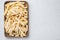 Frozen fries, on wooden tray, on white background, top view flat lay , with copyspace  and space for text