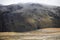 Frozen grassland with nomadic tents and misty hills behind on Tibetan Plateau