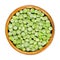 Frozen green peas, seeds of Pisum sativum in wooden bowl