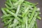 Frozen green pole beans close up in wok