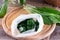 Frozen greens cubes on a wooden cutting board