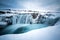 Frozen Hranabjargafoss waterfall during winter