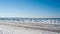 Frozen ice and sand dunes on beach in winter.