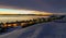 Frozen inuit houses among rocks and snow at the sunset fjord in outskirts of arctic capital Nuuk