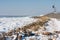 Frozen lake covered with stack of ice near breakwater