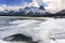 Frozen Lake and Distant Snowcapped Canadian Rocky Mountains Canmore Alberta