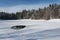 Frozen lake with little water hole