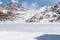 A frozen lake at the mountain valley in clear daylight