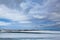 Frozen lake next to Highway 1 in Iceland with changing clouds in the sky