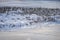 Frozen lake and reeds covered with rime and snow in sunlight