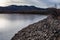 Frozen lake rocky shoreline with rocky mountains