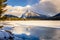 Frozen Lake with a Towering Mountain in Background at Sunset