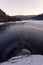 Frozen lake in a winter landscpae in sunset