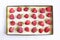 Frozen large strawberries, strawberries on a black tray