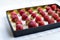 Frozen large strawberries, strawberries on a black tray