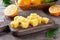 Frozen Lemon Juice cubes on a wooden table, closeup