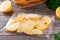 Frozen lemon slices in a bag on a wooden table