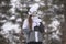 Frozen little girl in ski suit jacket and wool cap with warm gloves in winter cold park during christmas vacation