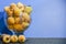 Frozen loquats Eriobotrya japonica in glass bowl on lilac background