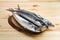 Frozen mackerel on wooden plate