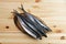 Frozen mackerel on wooden plate