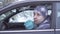 Frozen man in car shivering in winter cold