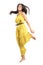 Frozen motion of young beautiful woman in yellow jumpsuit jumping