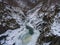 Frozen mountain river in granite gorge.