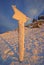 Frozen mountain signpost on mountain during winter