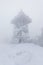 Frozen observation tower in foggy winter weather at Barania mountain in Poland