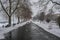 Frozen pathway in the park by the river on a winter day