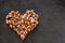 Frozen peeled mussels in shape of heart on slate stone background. Seafood, top view, flat lay, copy space.