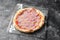 Frozen Pepperoni Pizza on Dark Background, Stone Baked Pizza Ready to Bake