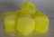 Frozen plastic cubes of yellow color close up