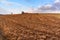 Frozen plowed field. Frost on agricultural field. Winter without snow. Frozen clay