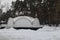 Frozen pond. February in the Moscow region. A pond lined with trees. Snow-covered shore at the end of the pond.