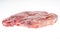 Frozen raw pork neck chops meat steak isolated on white.