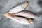 Frozen red mullet or barabulka raw fish, on gray stone table background, top view flat lay