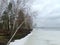 Frozen Rekyva lake and forest during cloudy winter day