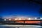 Frozen river with lighted lanterns automobile bridge.