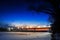 Frozen river with lighted lanterns automobile bridge.