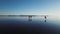 Frozen river Volga, near the city of Tolyatti. Friends skate on winter ice.